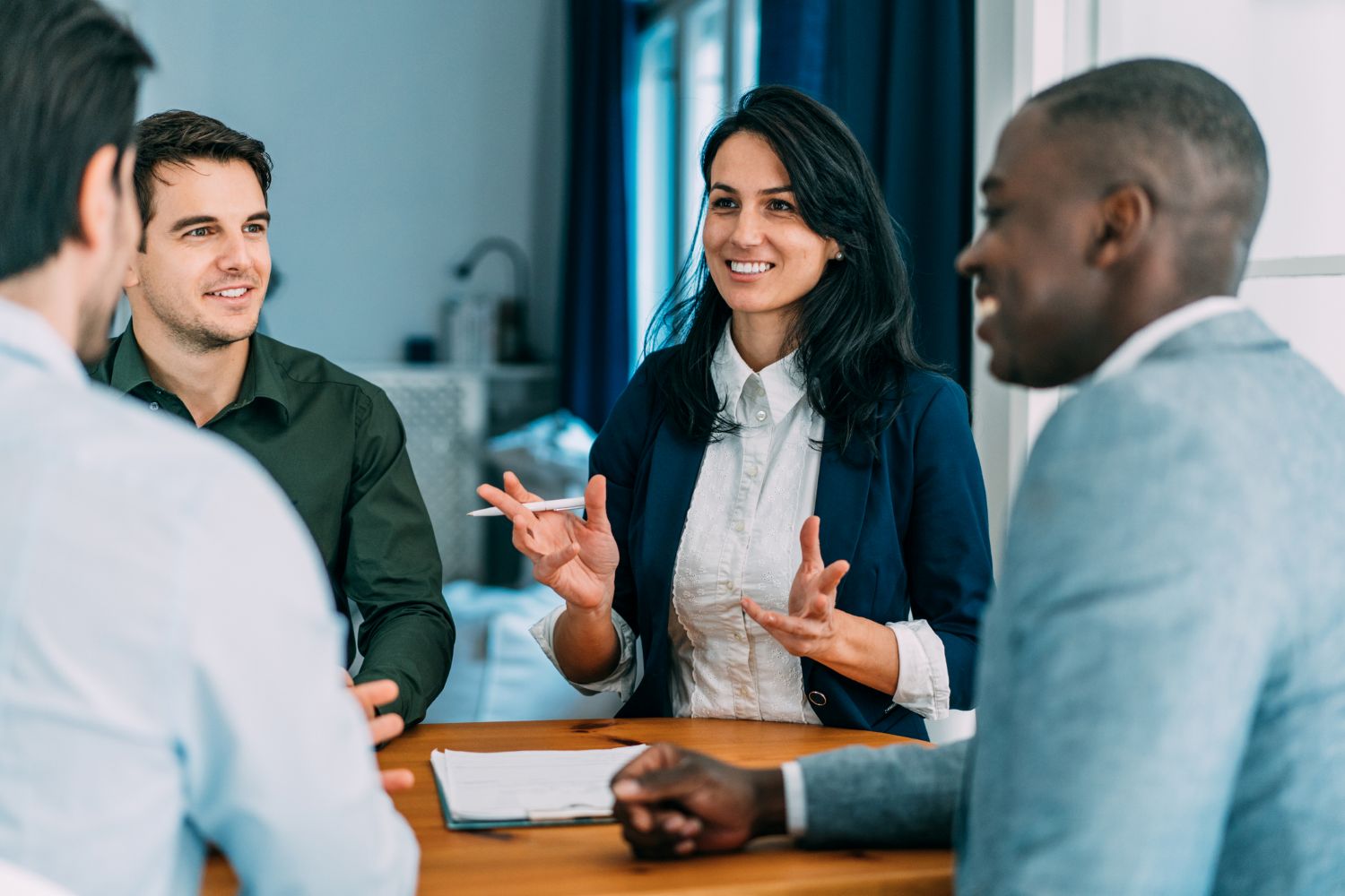 Group of four office professionals meeting at a table image